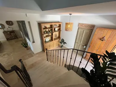 a staircase in a living room with a door at Mas Provençale entre Avignon et St Remy de Provence in Noves