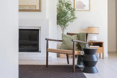 a living room with a chair and a fireplace at La Bastide Des As in Gordes