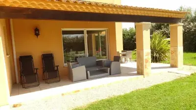 a patio with a couch and two chairs on it at Villa spacieuse à Cavaillon avec piscine privée in Cavaillon