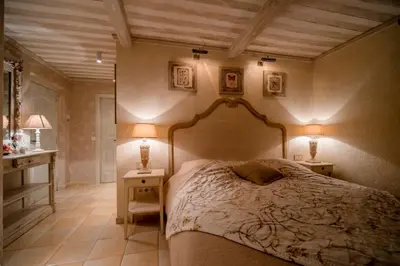 a bedroom with a large bed with two night stands at La maison de Inna in Bonnieux