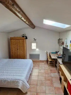 a bedroom with a bed and a table and a desk at Maison avec piscine privée, sauna et activités - Rendez-vous en Provence in Althen-des-Paluds