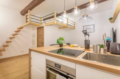 a kitchen with a sink and a staircase at Studio Aixois Mezzanine in Aix-en-Provence
