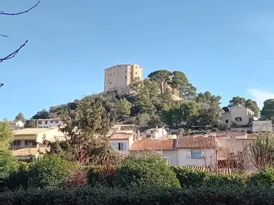 a castle on top of a hill with houses at T3 campagne Aix-en-Provence in Meyrargues