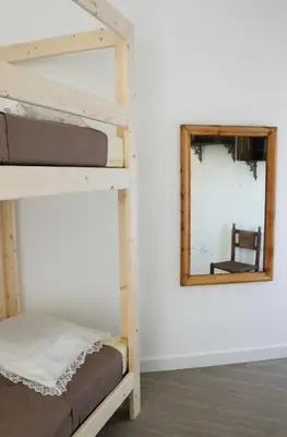 a bunk bed in a room with a mirror at Gîte de l'Escanson un temps pour soi in Robion en Luberon