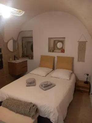 a bedroom with a bed with two towels on it at Petit bonheur in Lauris