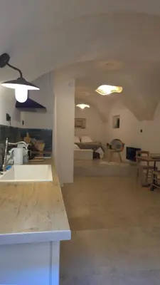 a kitchen and living room with a sink in a room at Petit bonheur in Lauris