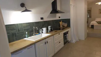 a kitchen with a sink and a counter top at Petit bonheur in Lauris