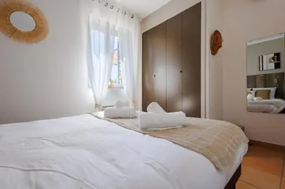 a bedroom with a large bed with two pillows on it at Lou Karo - Piscine partagée - Parking privé in Gordes