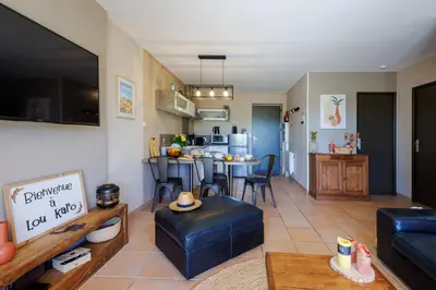 a living room with a couch and a table at Lou Karo - Piscine partagée - Parking privé in Gordes