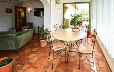 a patio with a table and chairs and a couch at Beautiful Home In La Bastide-Des-Jourdan in La Bastide-des-Jourdans
