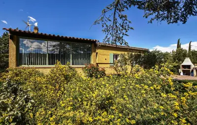 a house in the middle of a field of yellow flowers at Beautiful Home In La Bastide-Des-Jourdan in La Bastide-des-Jourdans