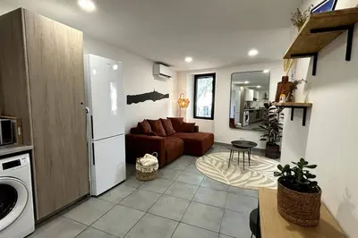 a living room with a couch and a kitchen at Très bel appartement climatisé - Chez Tom et Anna in Bédoin