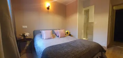 a bedroom with a bed with two pillows on it at Odette du Colorado, vue sur le colorado, jacuzzi, boisé in Rustrel
