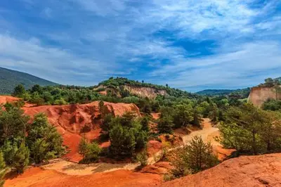 a view of a canyon with trees and red rocks at Odette du Colorado, vue sur le colorado, jacuzzi, boisé in Rustrel