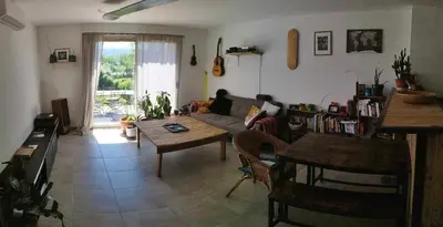 a living room with a couch and a table at Charmante maison de vacances en Luberon in Beaumettes