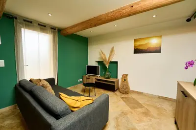 a living room with a couch and a television at Gîte entier en Campagne in Pernes-les-Fontaines