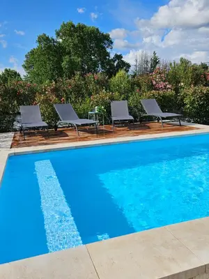 a swimming pool with lounge chairs next to at Gîte entier en Campagne in Pernes-les-Fontaines