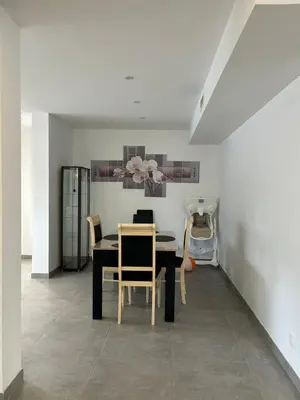 a dining room with a black table and chairs at Pitchoun in Velaux
