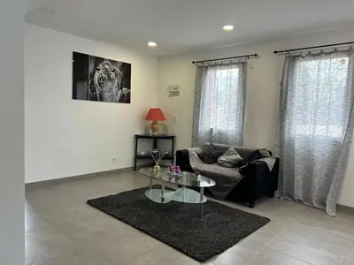 a living room with a couch and a table at Pitchoun in Velaux