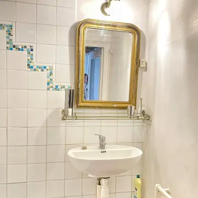 a mirror on a wall next to a room at Cassiopée - Charme et idéalement situé in Fontaine-de-Vaucluse