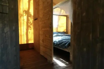 a mirror in a room with a bed in it at La Grisonne Chalet 2 in Revest-du-Bion