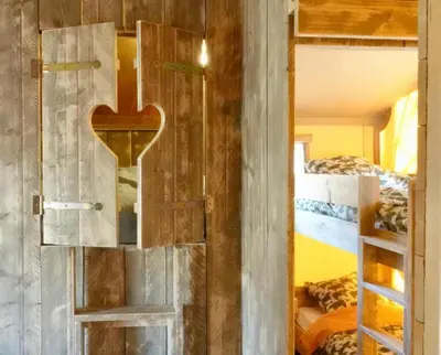 a door with a heart on it in a room with bunk beds at La Grisonne Chalet 1 in Revest-du-Bion