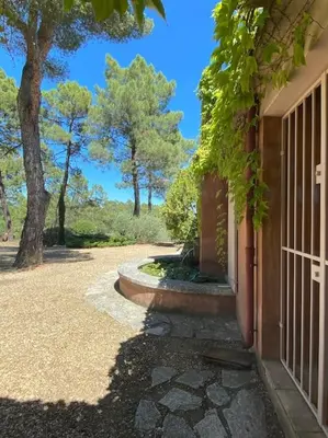 an entrance to a building with trees in the background at Villa Les Gourdeaux in Roussillon