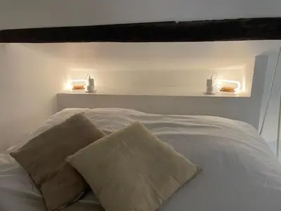 a bed with two lights on top of it at Studio cosy avec mezzanine in Salon-de-Provence