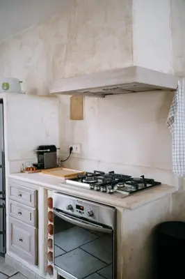 a kitchen with a stove top oven in a kitchen at Charming Village House in the Heart of Isle-sur-la-Sorgue in LʼIsle-sur-la-Sorgue