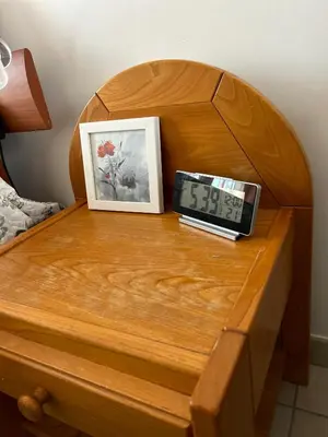a clock sitting on top of a wooden table at Villa Mirabelle 4 personnes in Châteauneuf-de-Gadagne