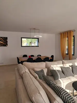 a living room with a large couch and a table at Villa SOFIA in Saint-Saturnin-les-Apt