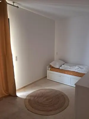 a bedroom with a bed and a rug on the floor at Villa SOFIA in Saint-Saturnin-les-Apt