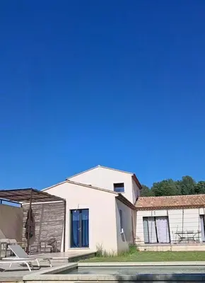 a white house with a boat in front of it at Villa SOFIA in Saint-Saturnin-les-Apt