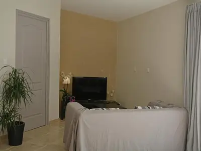 a living room with a couch and a flat screen tv at Farmhouse in Carpentras with Pool in Carpentras