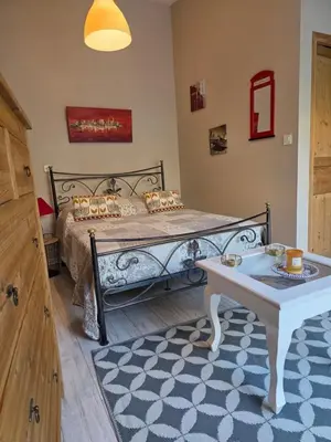 a bedroom with a bed and a table in it at Parenthèse caumontoise . in Caumont-sur-Durance