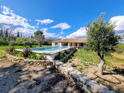 a swimming pool in front of a house at Les copains d'abord ! in Lacoste