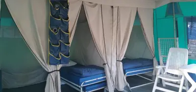a room with two chairs and a tent at Camping maeva Escapades Le Domaine des Chênes Blancs in Croagnes