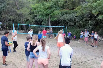 a group of people playing a game of volleyball at Camping maeva Respire La Vallée Heureuse in Orgon