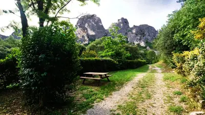 a picnic table in the middle of a dirt road at Camping maeva Respire La Vallée Heureuse in Orgon