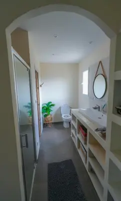 a bathroom with a sink and a toilet and a mirror at Magnifique villa familiale avec piscine in Caumont-sur-Durance