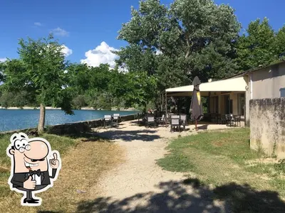 a house with a cartoon character next to the water at Gîte de L'Embuissonnade in Montfuron