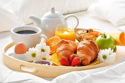 a tray of breakfast food with croissants fruit and coffee at Charmant Appartement Proche Centre Balcon Belle Vue Cathédrale in Aix-en-Provence