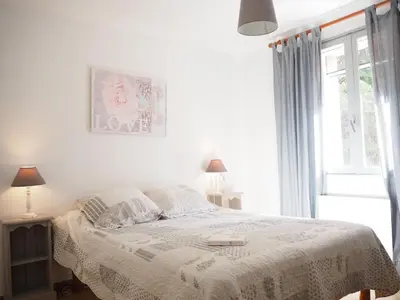 a white bedroom with a bed and a window at Holiday Home in Provence near Mont Ventoux in Bédoin