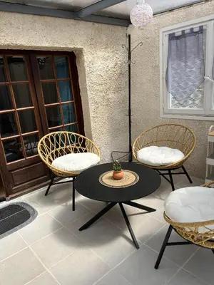 a patio with a table and two chairs and a table at La Port-Gentillaise in Aix-en-Provence