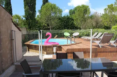 a pool with a plastic pink flamingo in a yard at Les Romarins dans le Mas de la PERRINE entre AVIGNON LUBERON Mt VENTOUX in Monteux