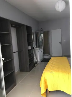 a bedroom with a bed with a yellow blanket at Maison au pied du mont ventoux in Carpentras