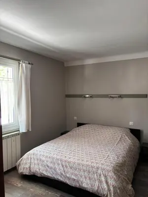 a bedroom with a bed and a window at Les Juliens in Gordes