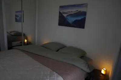 a bedroom with a bed with two lights on at Appartement Suite Privilège avec Parking in Salon-de-Provence