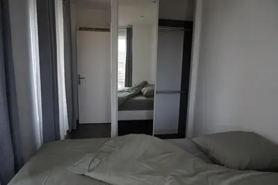 a bedroom with a bed and a mirror at Appartement Suite Privilège avec Parking in Salon-de-Provence