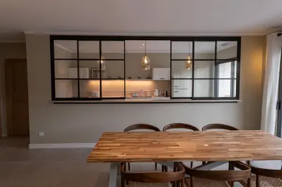 a dining room with a wooden table and chairs at Comme à la maison in Châteauneuf-de-Gadagne